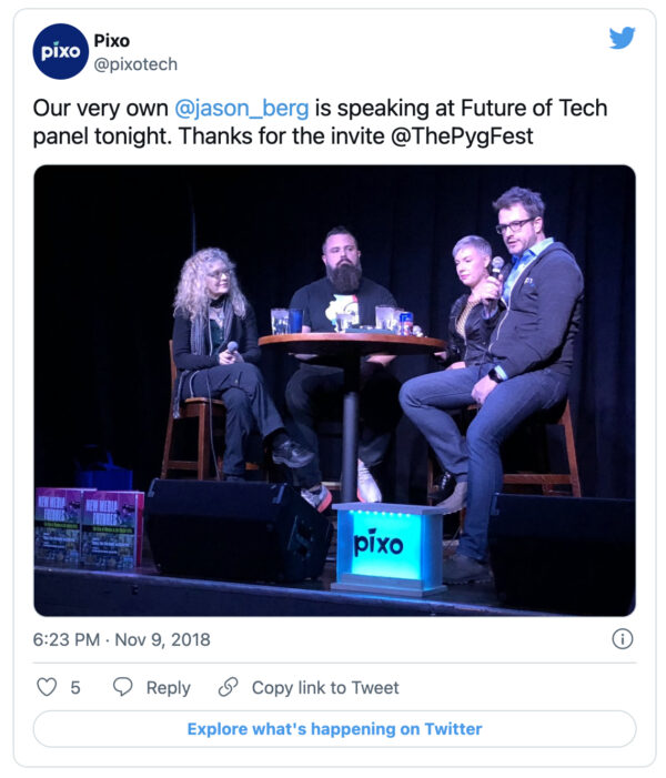 A screenshot of a tweet showing four people speaking onstage next to a glowing blue Pixo box.