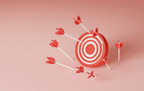 a picture of a target with several arrows landing on and around it, missing the bullseye