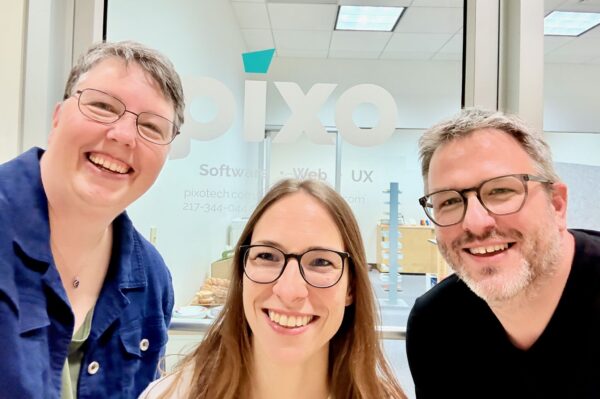 Pixo staff pose in front of new office in Research Park