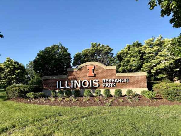 Research Park brick monument sign amid a clear blue sky and lush green landscaping