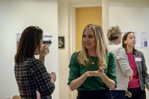 Pixo's Leah Rainey and Jackie Ritter standing talking to each other.