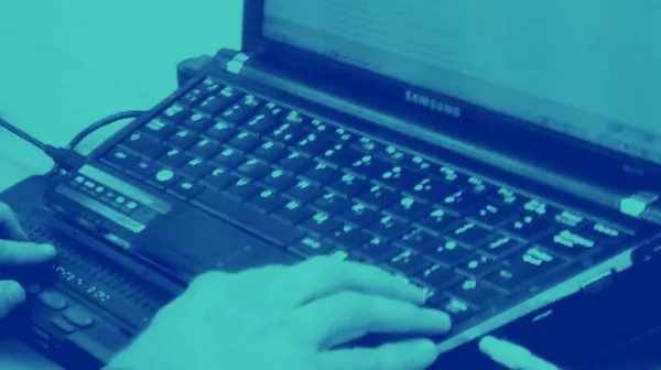 Braille display connected to a laptop, representing digital accessibility.