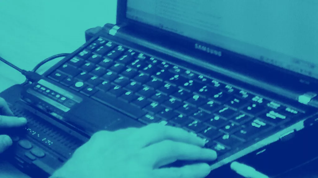 Braille display connected to a laptop, representing digital accessibility.
