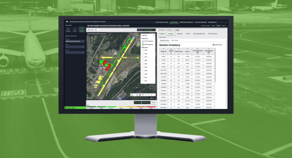 A desktop monitor displays a screenshot of the web application, over a faded green background photo of an airplane on a runway.