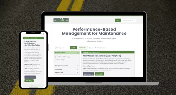 mobile phone and laptop computer displaying the homepage of the PBM4M website over a road pavement textured background