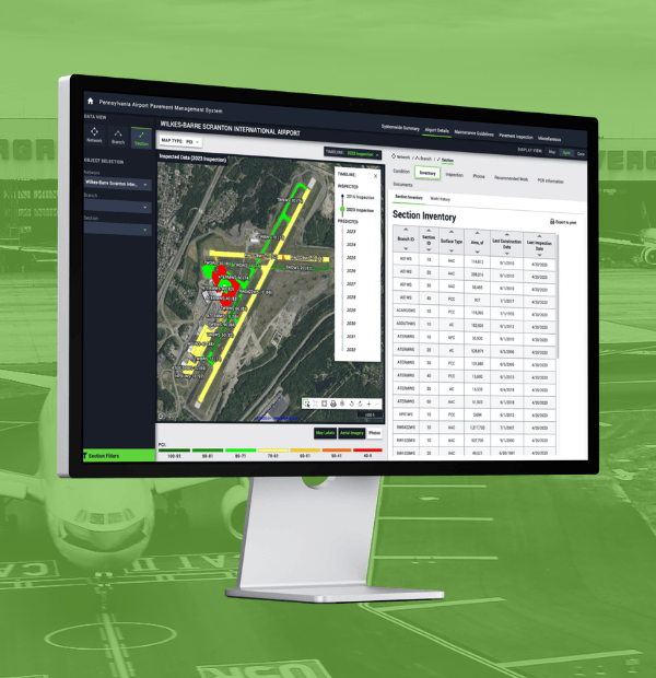 An angled desktop monitor displays a screenshot of the web application, over a faded green background photo of an airplane on a runway.