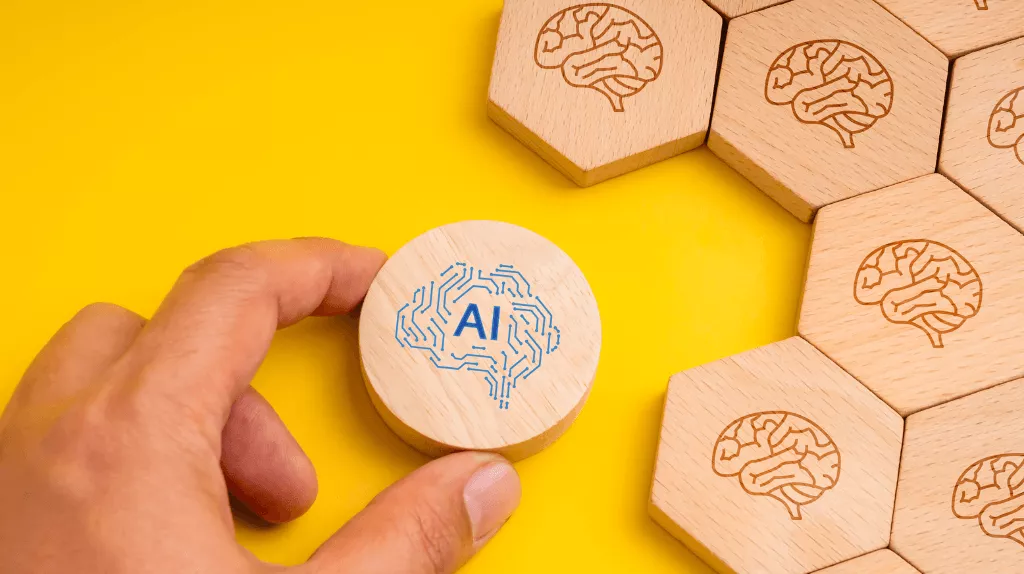 a hand attempting to fit a round token with an AI icon among a collection of hexagonal wooden tokens with brain icons