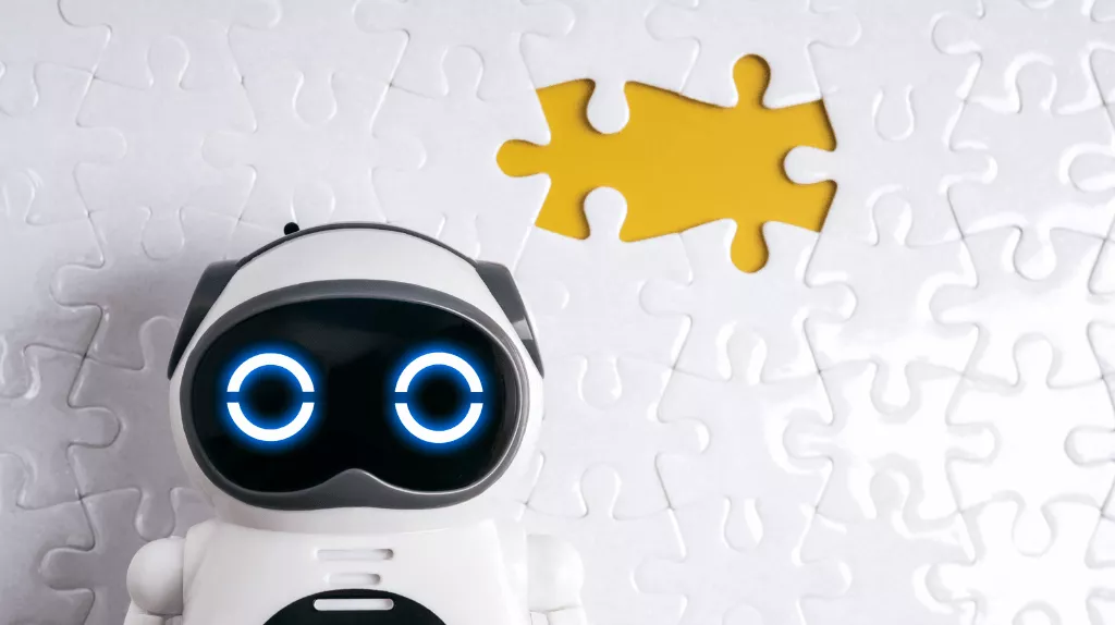 AI robot toy in front of a white puzzle piece background with a yellow cutout where a piece is missing.
